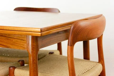 A mid century teak dining table with four chairs from the 50s 60s Danish De.. Stock Photos