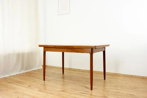 A mid century teak dining table with four chairs from the 50s 60s Danish De.. Stock Photos