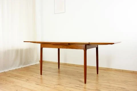 A mid century teak dining table with four chairs from the 50s 60s Danish De.. Stock Photos