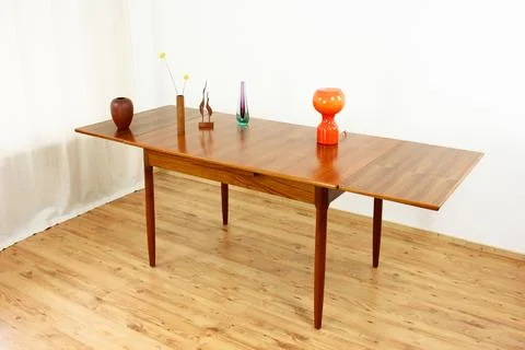 A mid century teak dining table with four chairs from the 50s 60s Danish De.. Stock Photos