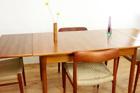 A mid century teak dining table with four chairs from the 50s 60s Danish De.. Stock Photos