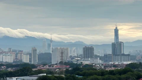 Mid clouds rollover Titiwangsa range with Kuala Lumpur city view Stock Footage 144034425