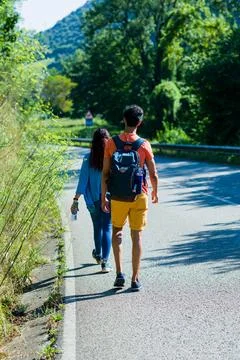 Mid Couple walking on the road. Danger traffic safety education for tourism Stock Photos