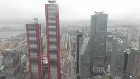 Mid-day over a downtown skyscraper around Seoul International Financial Center Stock Footage 240757360