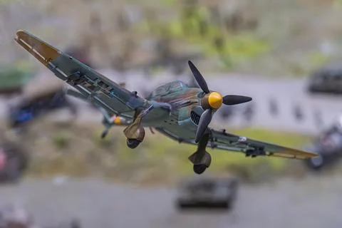 Mid-flight old-style fighter plane with camouflage pattern, likely German ori Foto stock