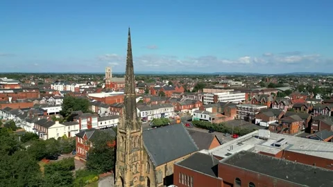 Mid-level aerial fly by clip of St George's URC Church with tall spire Stock Footage 244813965