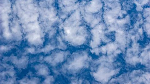 Mid-level moisture and wind shear create altocumulus cloud patterns Stock Photos