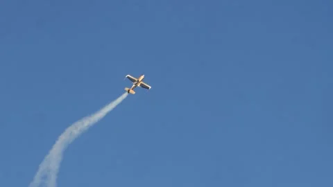 Mid-loop acrobatic maneuver at Oeiras airshow with yellow-green wings and Stock Footage 291774725