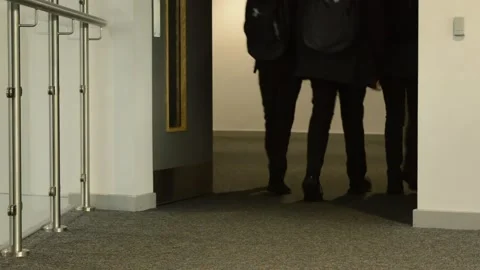 Mid low angle shot of Students walking through coridoor in school Stock Footage 247401589
