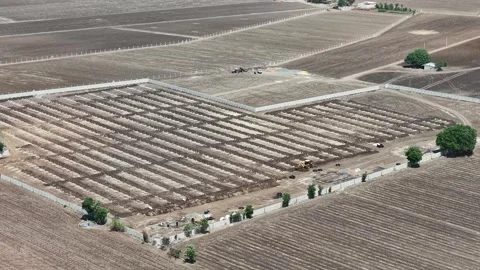 Mid range downward aerial view mapping a secured commercial green energy project Vídeo Stock 339912395