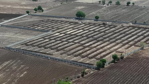 Mid-range overhead drone shot capturing organized ground preparation work Stock Footage 337247167