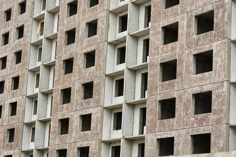 Mid range view raw concrete blocks and empty window voids, modular housing .. Stock Photos