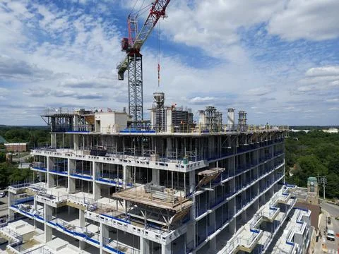 Mid-Rise Concrete Building Under Construction with Tower Crane Stock Photos