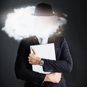 Mid section of businessman holding computer  against grey background Fotos de archivo