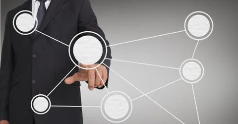 Mid-section of businessman touching digital screen against grey background Foto stock