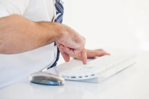 Mid section of businessman using computer keyboard Fotos de archivo