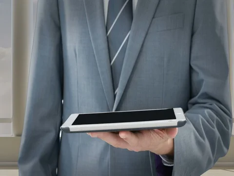 Mid section of businessman using digital tablet Stock Footage 73084048
