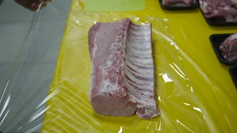 Mid section of butcher packing red meat Stock Footage 125168148