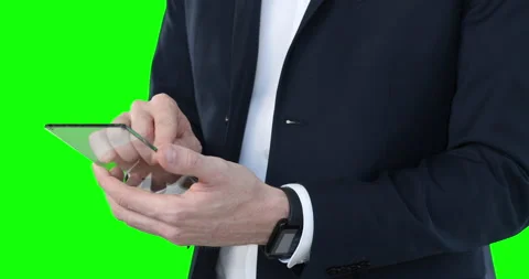 Mid section of a Caucasian man holding a transparent screen on green background Stock Footage 130828938