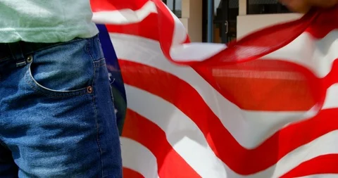 Mid section of Caucasian schoolboy holding American flag in school 4k Stock Footage 106949022