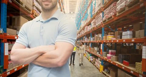 Mid section of caucasian worker arm crossed in an warehouse Stock Photos