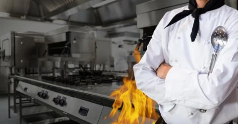 Mid section of chef standing with arms crossed in kitchen Stock Photos
