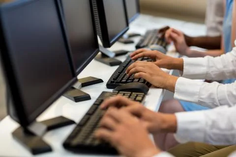 Mid section of colleagues working on computer Fotos de archivo