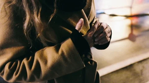 Mid-section of confused woman with hands clasped standing on street at night 스톡 동영상 122395953