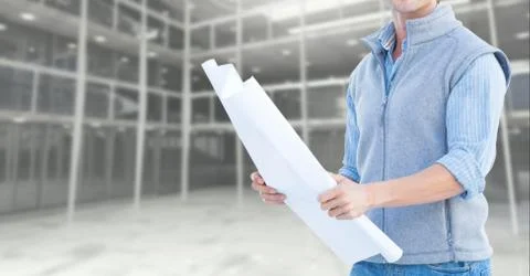 Mid section of construction engineer holding a plan Stock Photos