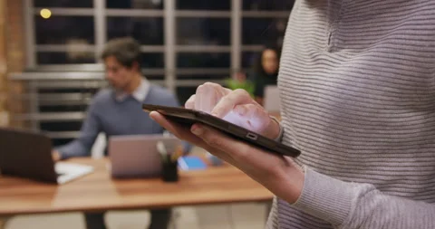 Mid section of creative businesswoman using digital table in modern office 動画素材 135456875