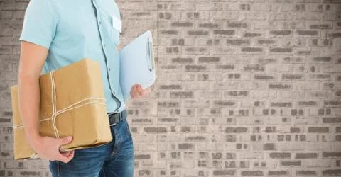 Mid section of delivery man holding parcel box and clipboard 写真素材