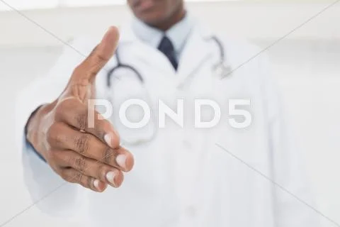Mid section of doctor offering a handshake Stock Photos