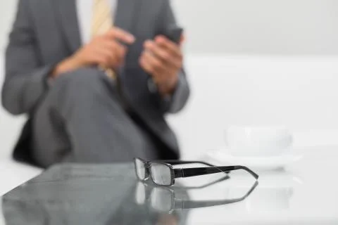 Mid section of an elegant businessman text messaging Stock Photos