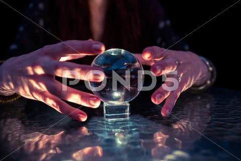 Mid Section Of Fortune Teller Woman Using Crystal Ball