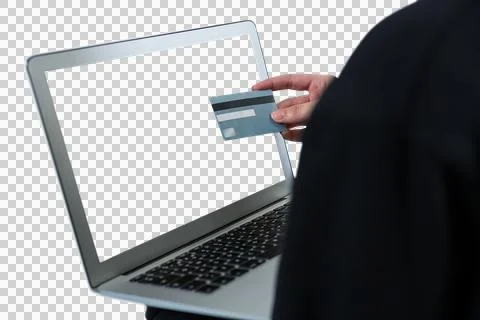 Mid section of hacker using laptop and debit card Stock Photos