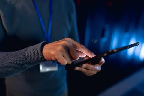 Mid section of male engineer using digital tablet in computer server room Stock Photos