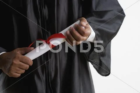 Mid Section Of Man In Graduation Gown Holding Diploma