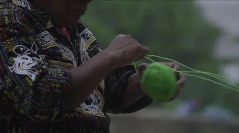 Mid section of man making ball of wool, Guatemala Stockbeeldmateriaal 63056038