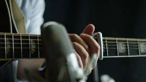 Mid section of man playing guitar chords Stock Footage 108931885
