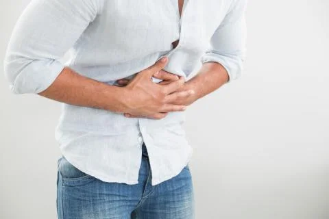 Mid section of man suffering from stomach pain Stock Photos