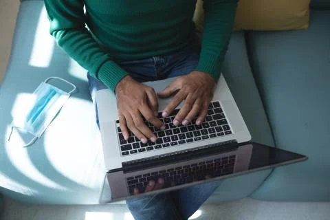 Mid section of man using a laptop Stock Photos