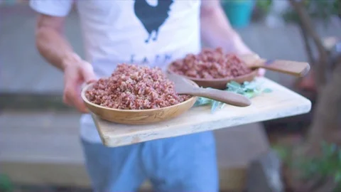 Mid-section of man walking with minced meat in park Stock-Footage 76136789