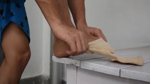 Mid section of man wearing knee cap on leg in clinic Stock Footage 130682069