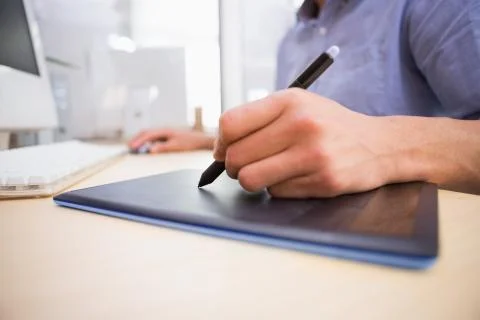 Mid section of man working on computer and digitizer Foto stock