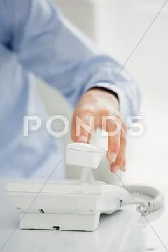 Mid-Section Of Mans Hand Receiving A Phone