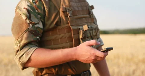 Mid section of military soldier using mobile phone Stock Footage 93311989