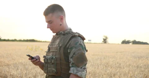 Mid section of military soldier using mobile phone Stock Footage 93312542
