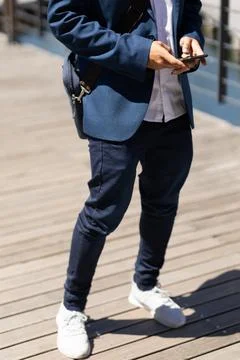 Mid section of mixed race man using smartphone in street Fotos Stock