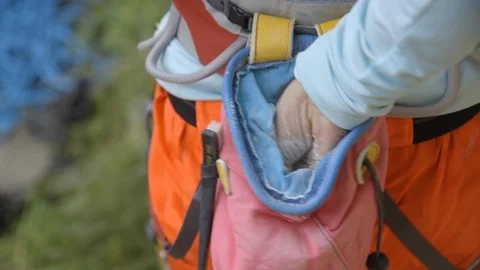 Mid-section of mountaineer rubbing powder on hand Stock Footage 89971823