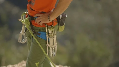 Mid-section of mountaineer standing with equipment around waist Stock Footage 89971765